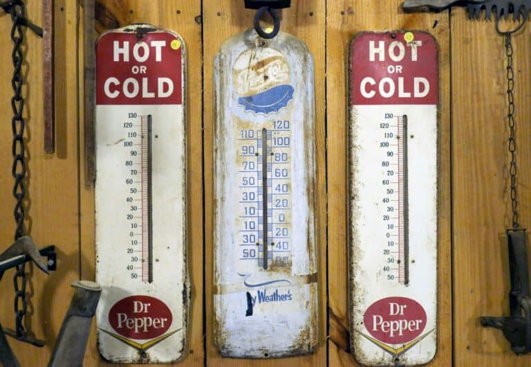 Vintage Hot Cold Thermometers in Rustic Setting.