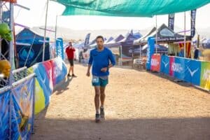 Runner at Race Event, Running Coach Support, Marathon Training Assistance.