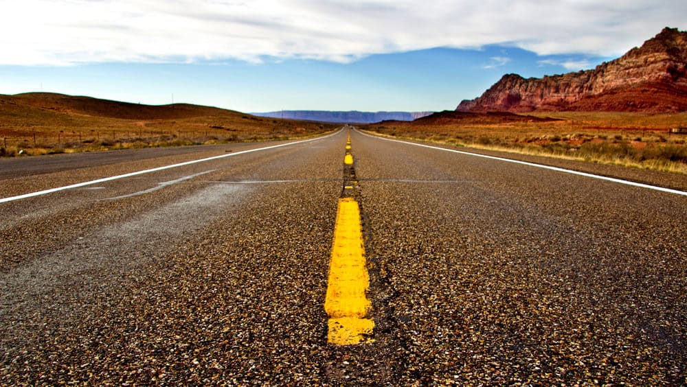 Scenic open road in a desert landscape, perfect for marathon or running training sessions.