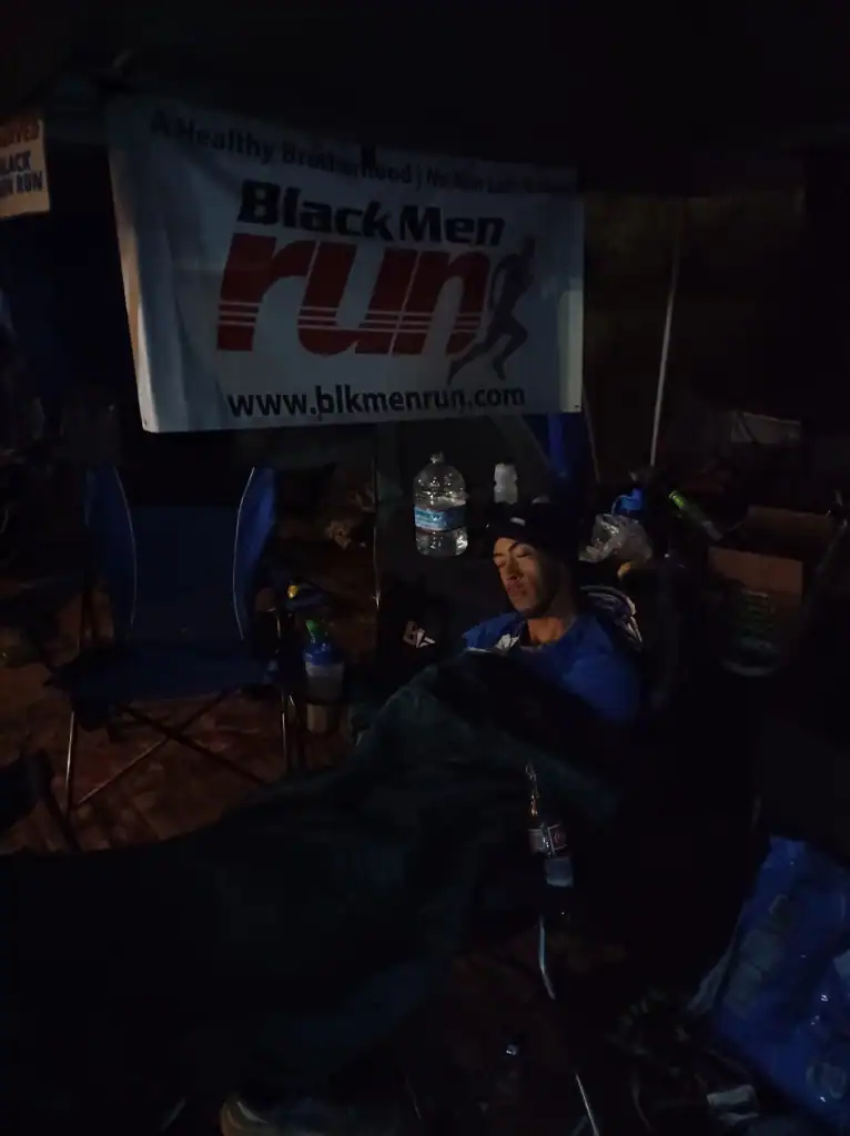 Support and community for Black Men Run participants during night marathons.